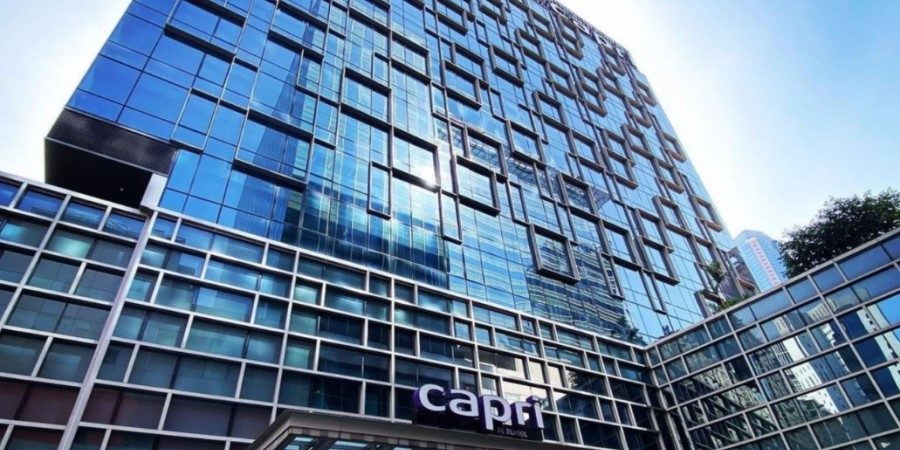 Exterior of a tall building with a "Capri" sign, representing Capri By Fraser in China Square, Singapore.